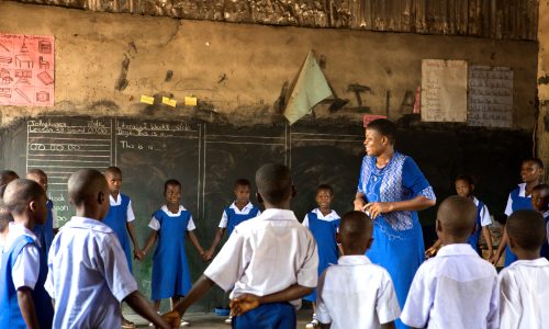 Teacher and students in a Nigerian classroom.