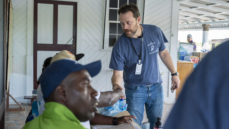 Jason Carter reaches out to shake someone's hand