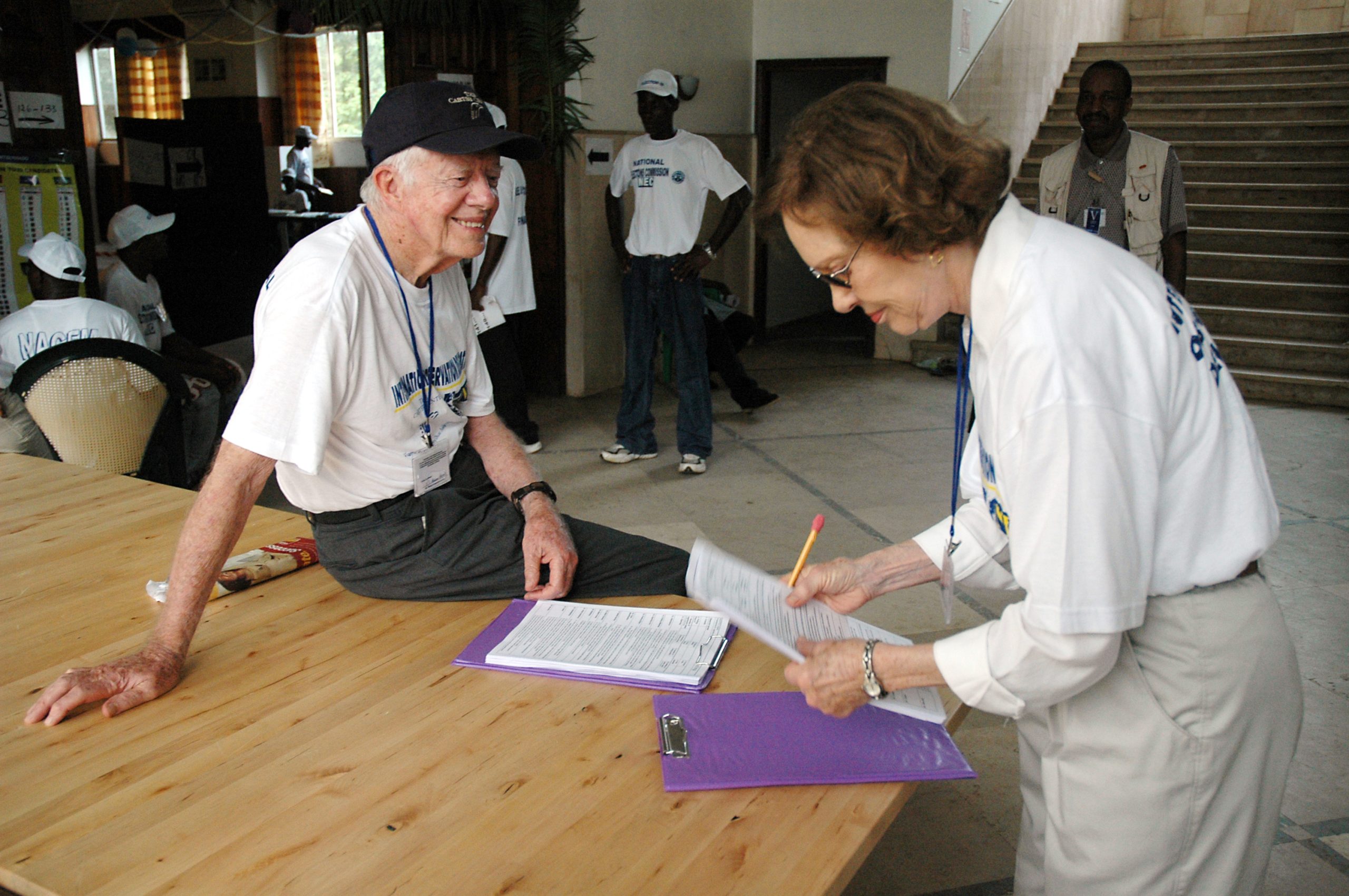 Jimmy and Rosalynn Carter look at poll closing paperwork.