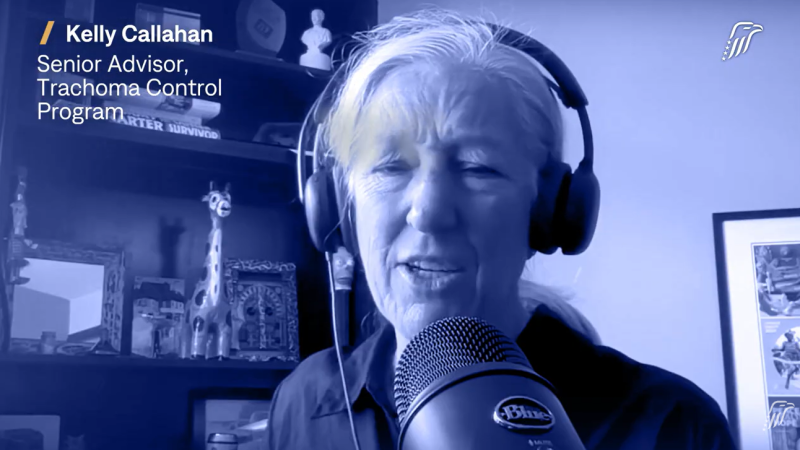 a woman speaks into a microphone